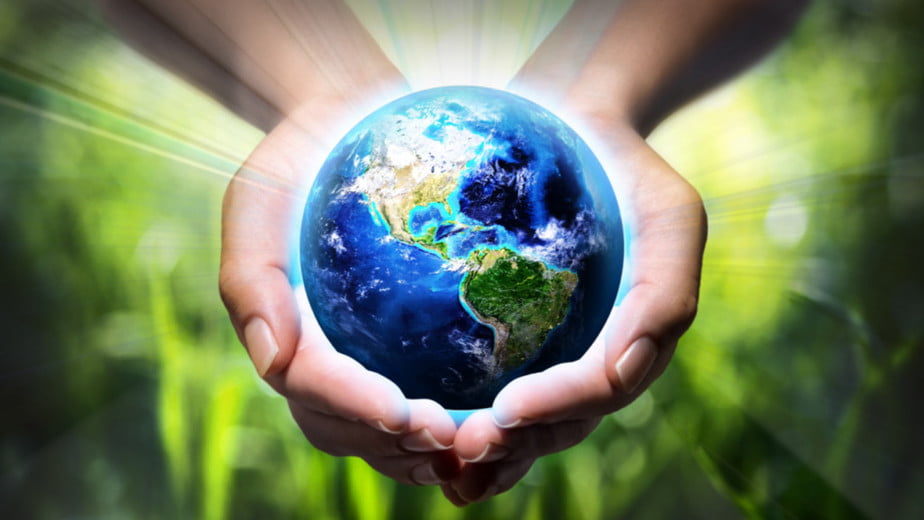 two hands holding an illustration of mother earth